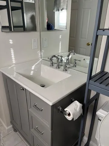 a bathroom with a sink vanity and a mirror