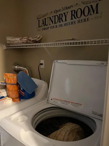 a bedroom with a bed next to a window