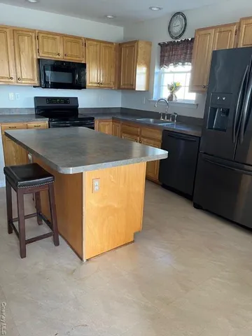 a kitchen with stainless steel appliances granite countertop a stove a sink dishwasher and a refrigerator