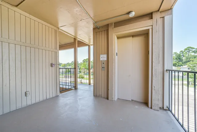 a view of a porch with wooden floor and windows