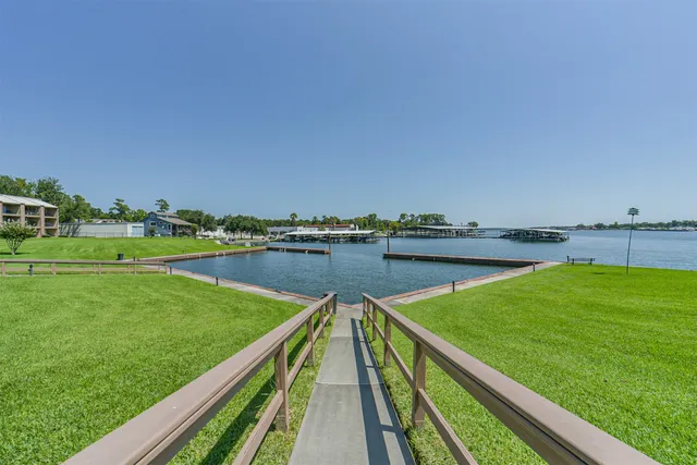 a view of swimming pool with a yard and large trees