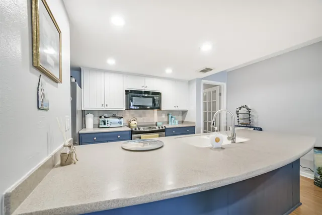 a living room with furniture kitchen view and a couch