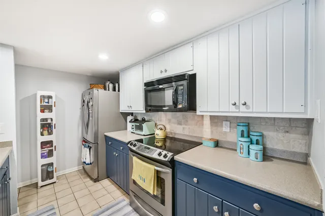 a kitchen with stainless steel appliances a stove microwave and refrigerator