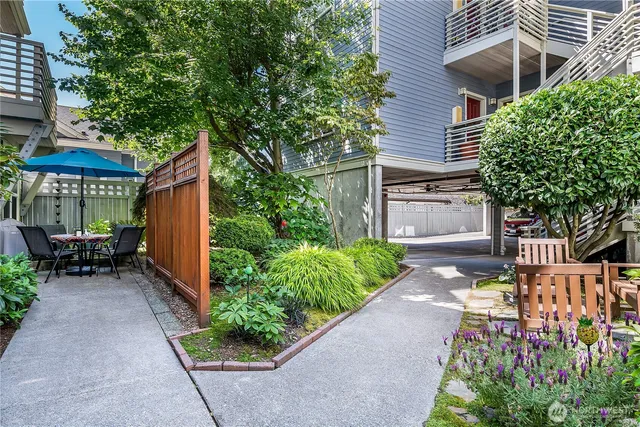 a view of a patio with a table and chairs under an umbrella