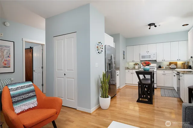 a kitchen with stainless steel appliances granite countertop a refrigerator and a stove top oven