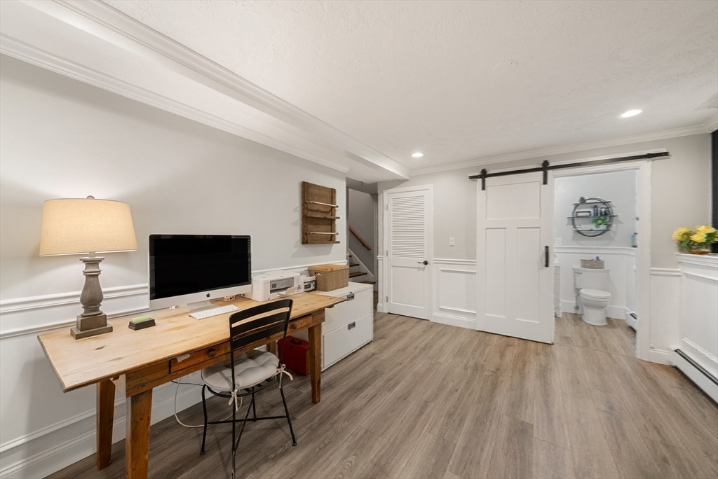 12 Nancy Road Natick, MA 01760 - Photo 16 of 25 a view of a workspace with furniture and wooden floor