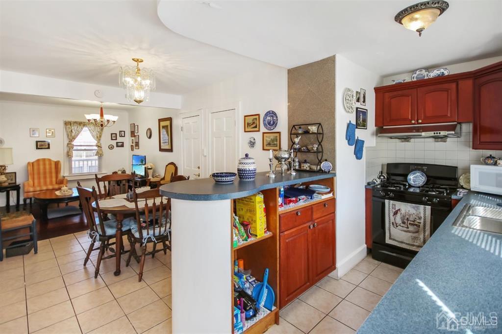 122 South Lincoln Avenue Middlesex, NJ 08846 - Photo 11 of 37 a kitchen with stainless steel appliances granite countertop a refrigerator and a stove top oven
