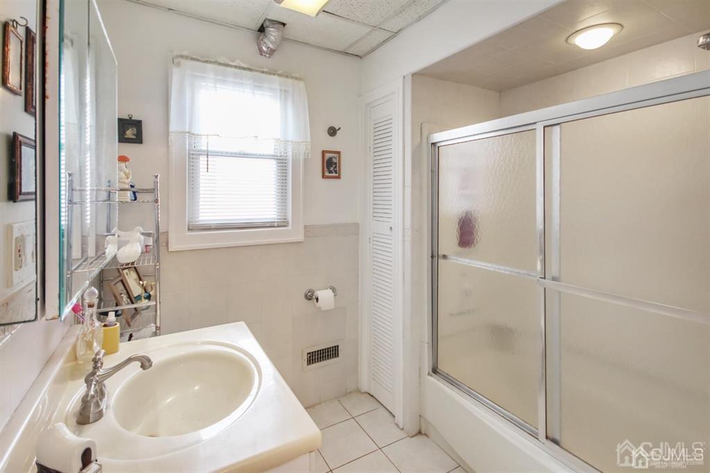 122 South Lincoln Avenue Middlesex, NJ 08846 - Photo 12 of 37 a bathroom with a sink toilet and shower