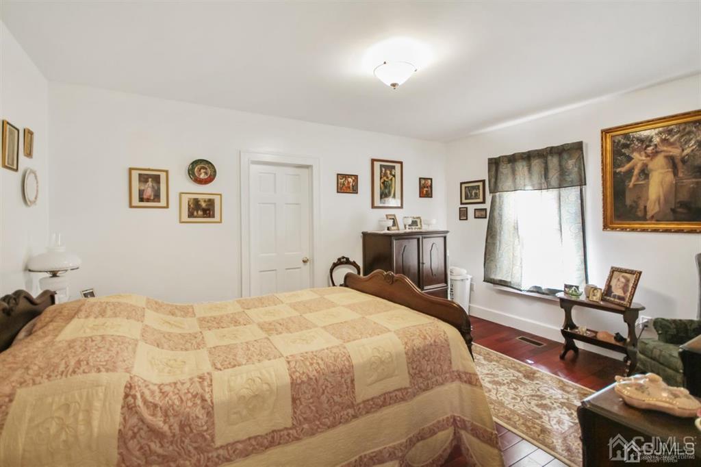 122 South Lincoln Avenue Middlesex, NJ 08846 - Photo 17 of 37 a bedroom with a bed and wooden floor