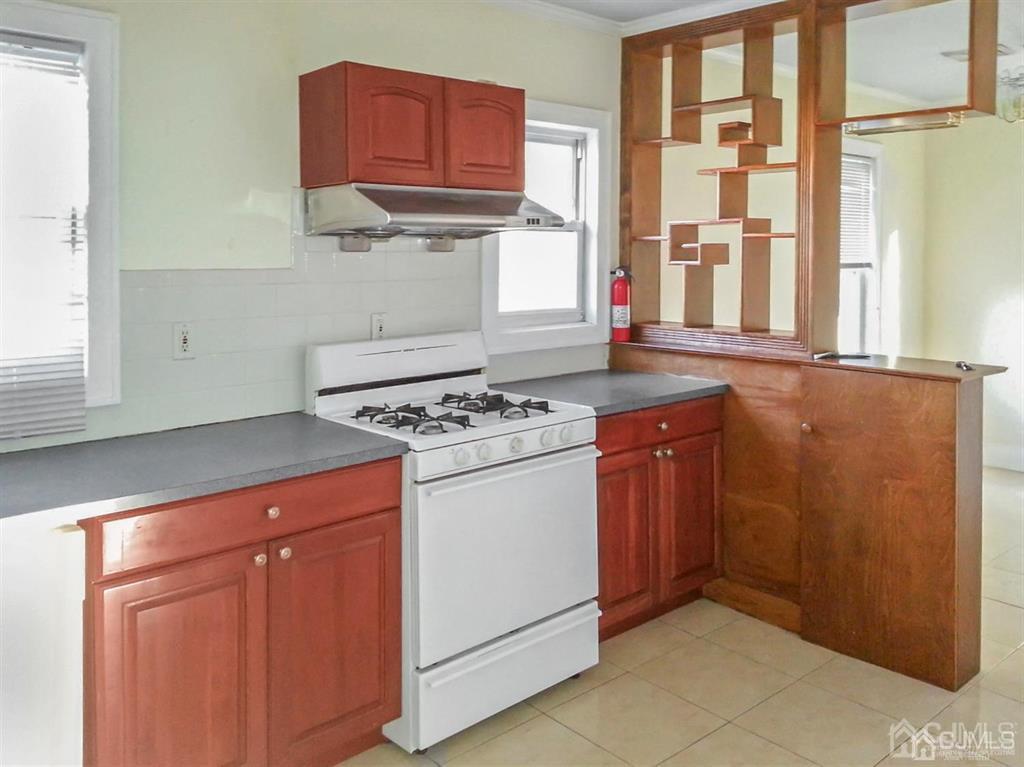 122 South Lincoln Avenue Middlesex, NJ 08846 - Photo 24 of 37 a kitchen with stainless steel appliances granite countertop a stove a sink and a microwave
