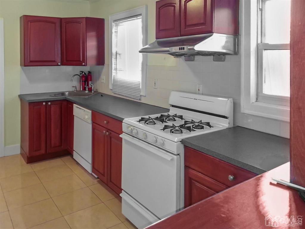 122 South Lincoln Avenue Middlesex, NJ 08846 - Photo 25 of 37 a kitchen with stainless steel appliances granite countertop a stove a refrigerator and a cabinets