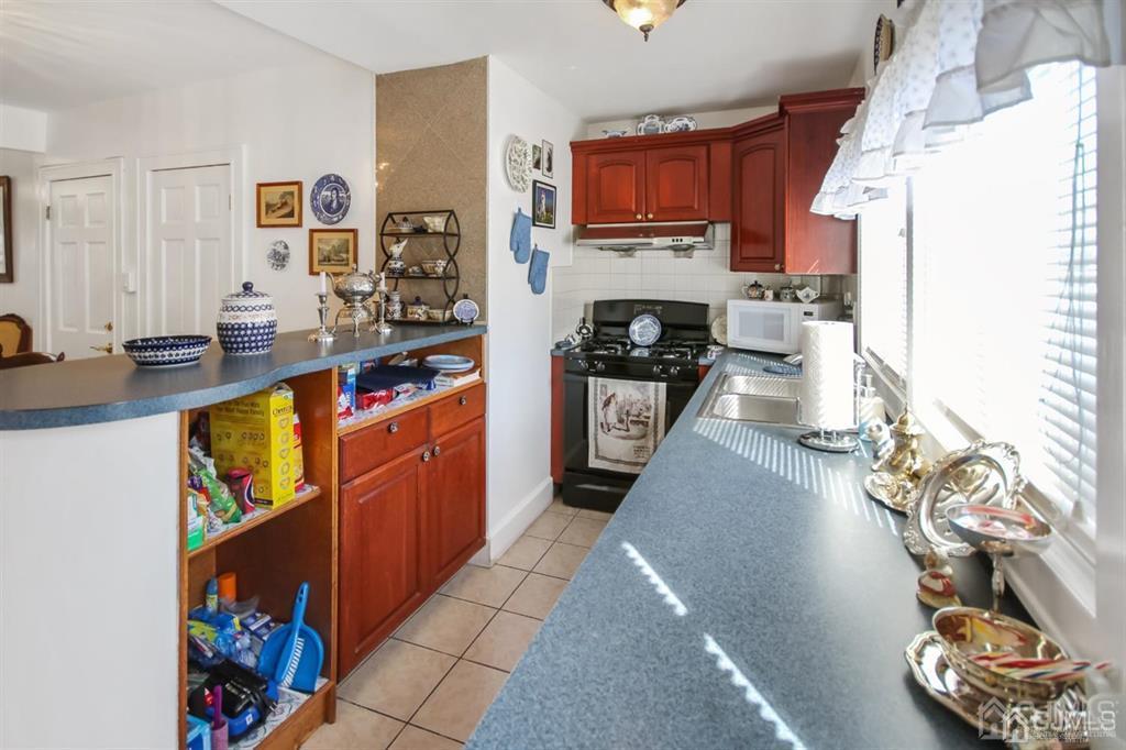122 South Lincoln Avenue Middlesex, NJ 08846 - Photo 9 of 37 a kitchen with stainless steel appliances a stove a sink a refrigerator and a cabinets