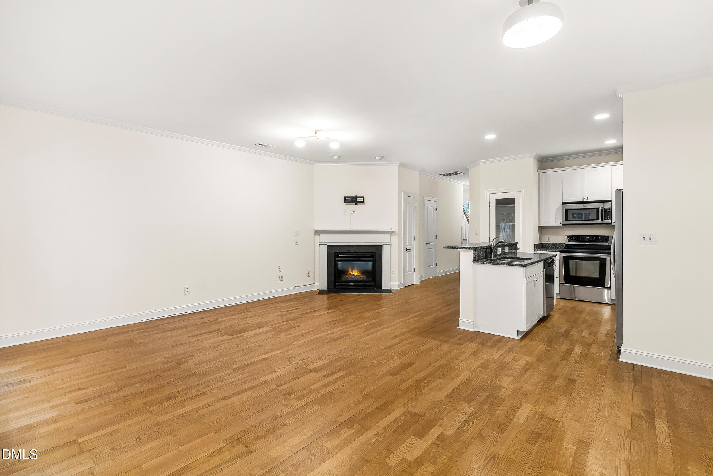 2822 Pickett Road, Unit 154 Durham, NC 27705 - Photo 10 of 31 a view of empty room with kitchen and fireplace