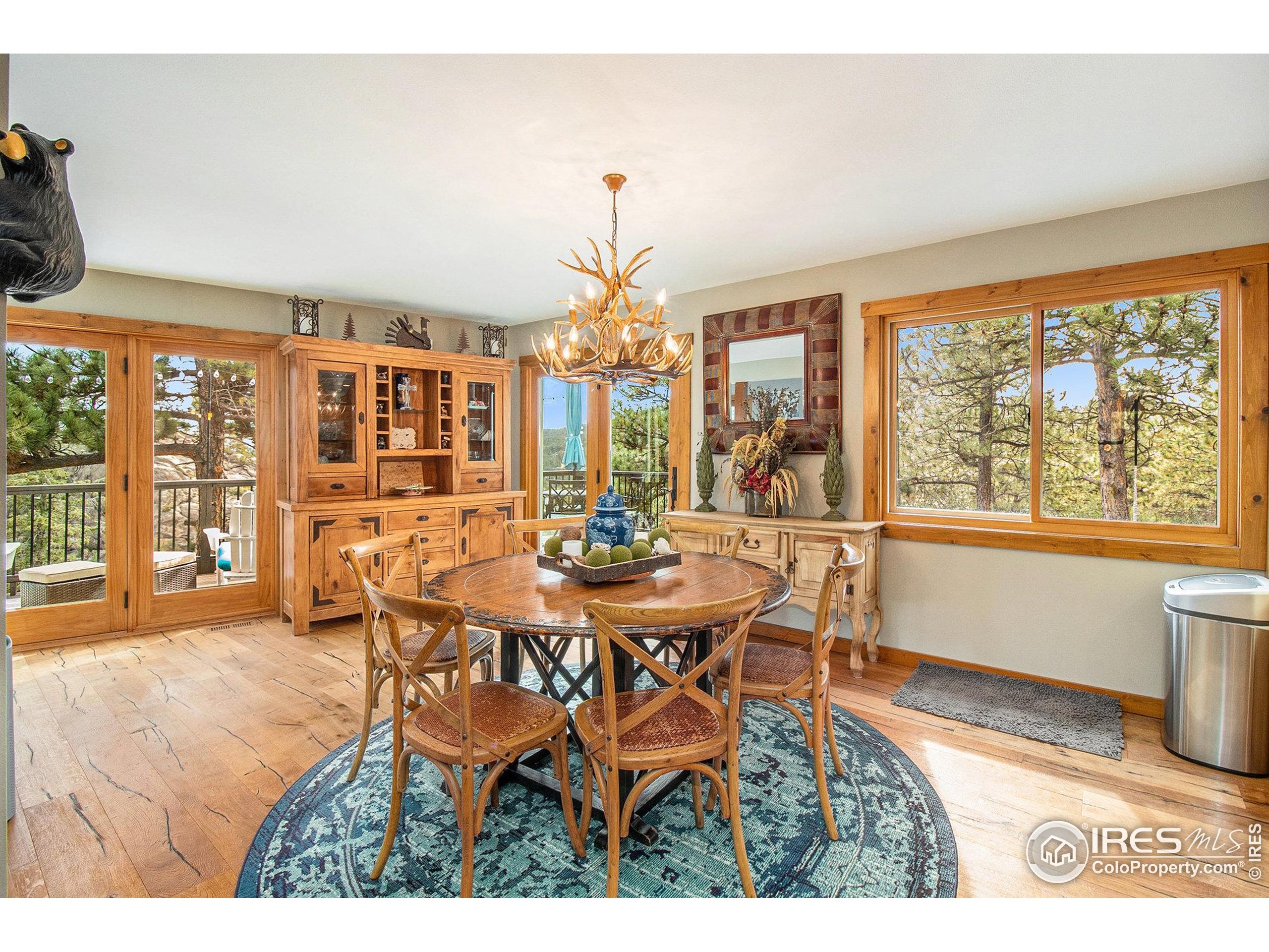270 Choctaw Road Lyons, CO 80540 - Photo 11 of 26 a dining room with furniture a chandelier and wooden floor