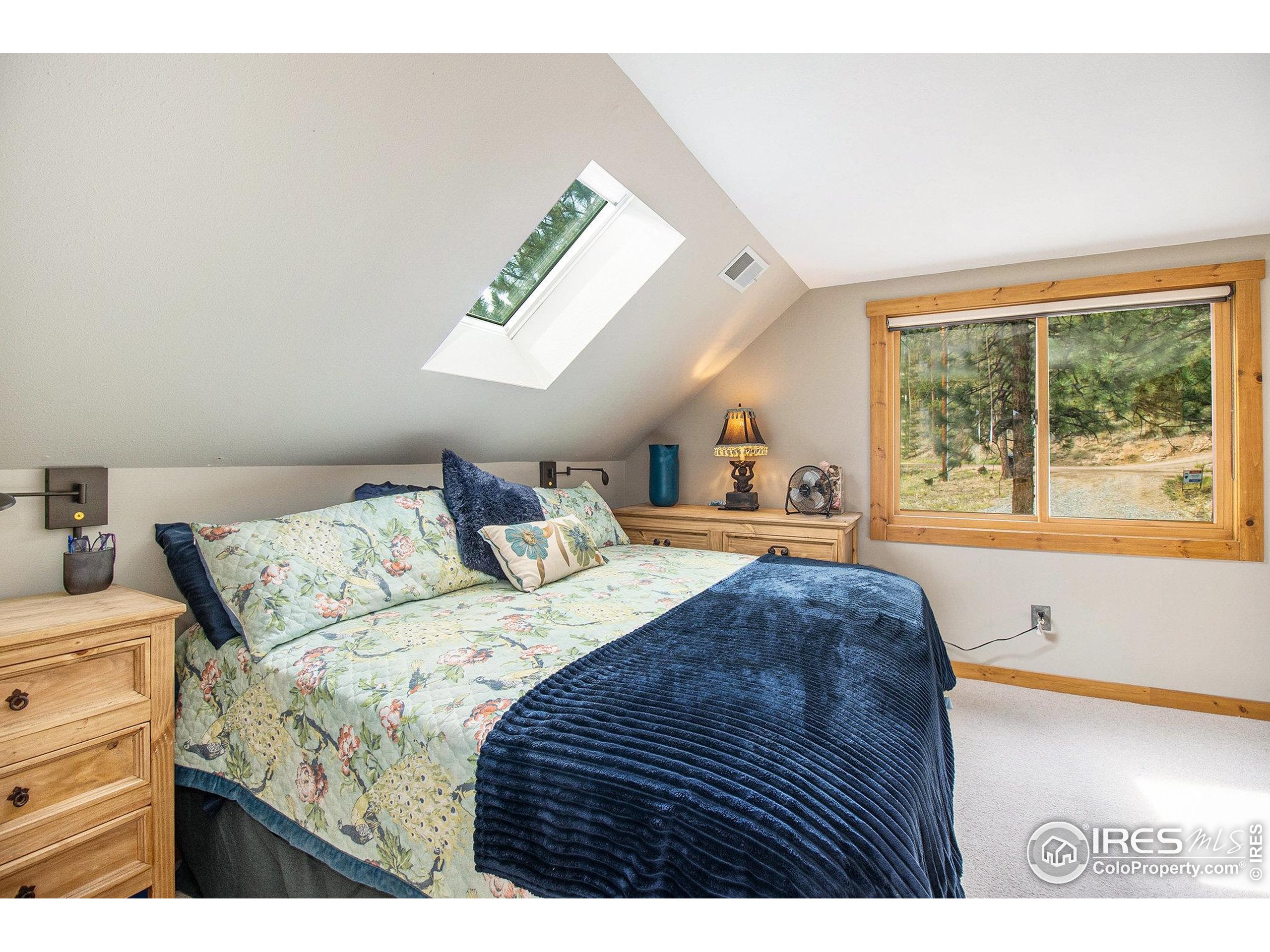 270 Choctaw Road Lyons, CO 80540 - Photo 15 of 26 a bedroom with a bed and a large window