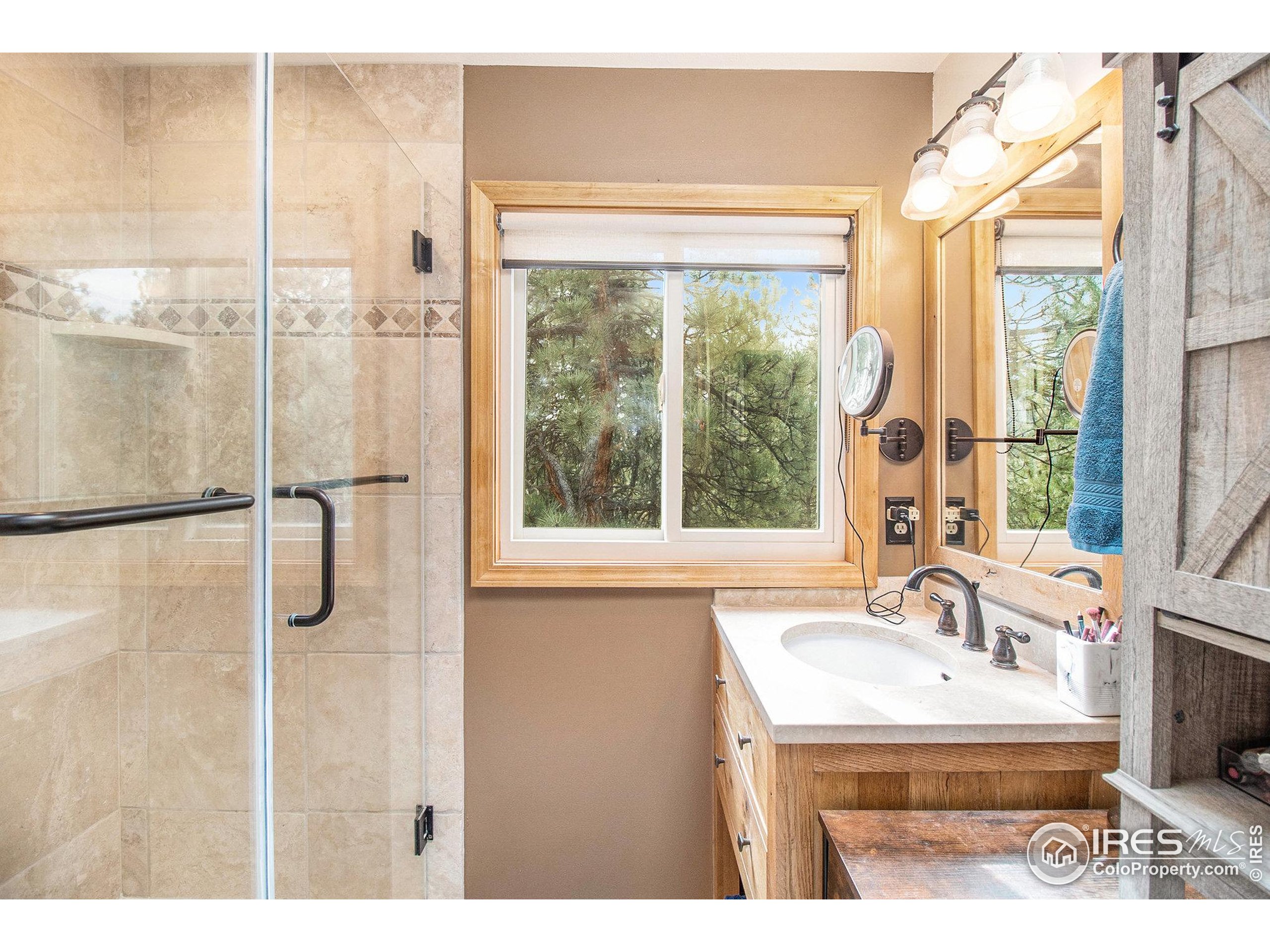 270 Choctaw Road Lyons, CO 80540 - Photo 16 of 26 a bathroom with a sink and a large mirror