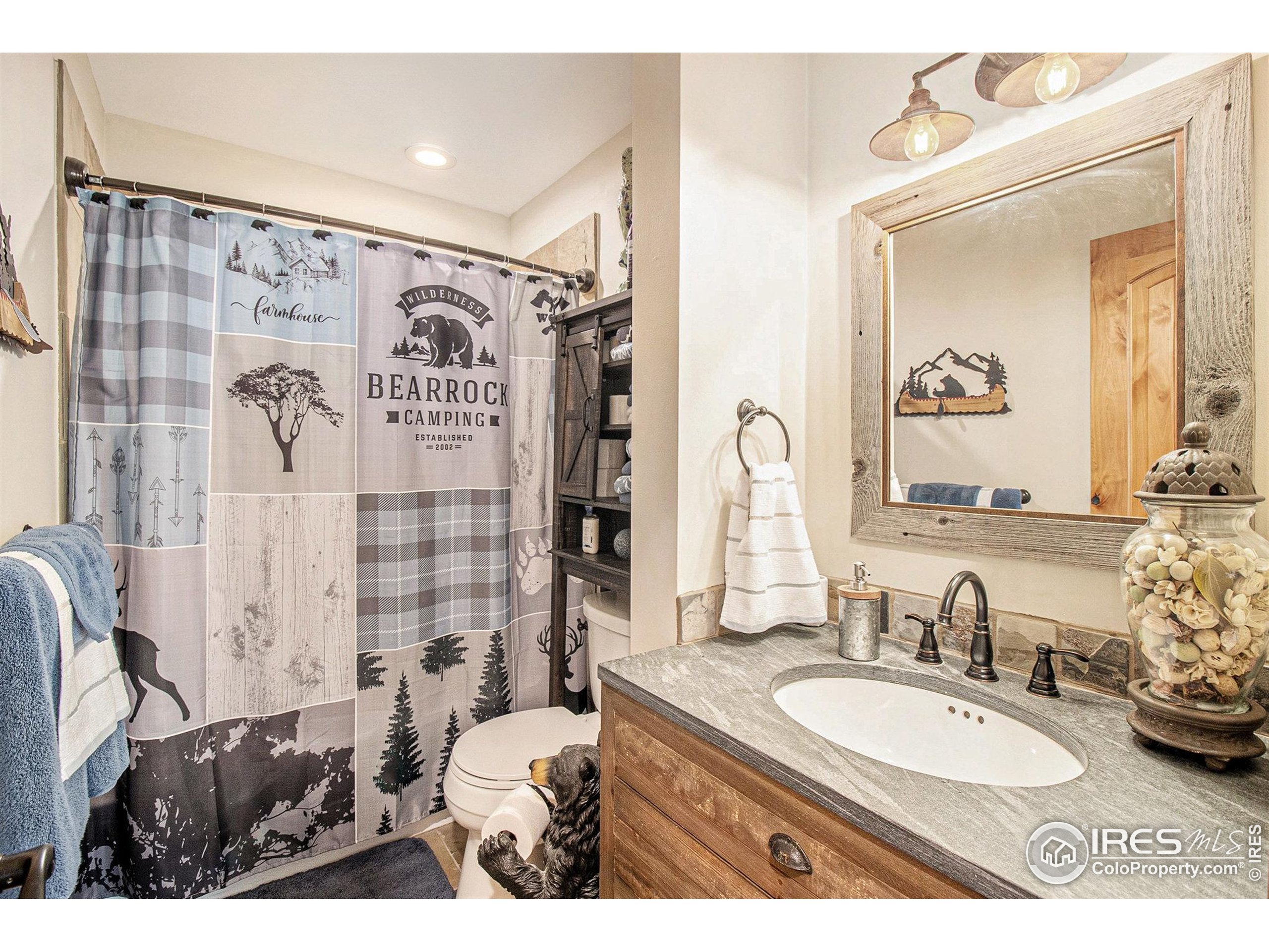 270 Choctaw Road Lyons, CO 80540 - Photo 20 of 26 a bathroom with a granite countertop sink mirror and shower