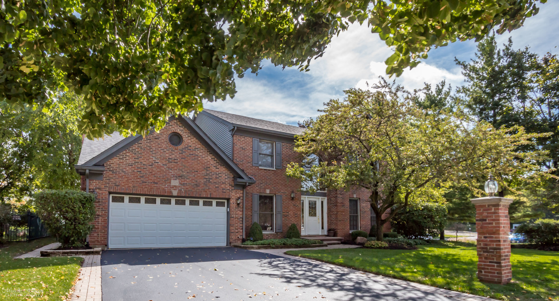 125 Briargate Road Cary, IL 60013 - Photo 1 of 24 a front view of a house with a garden and tree