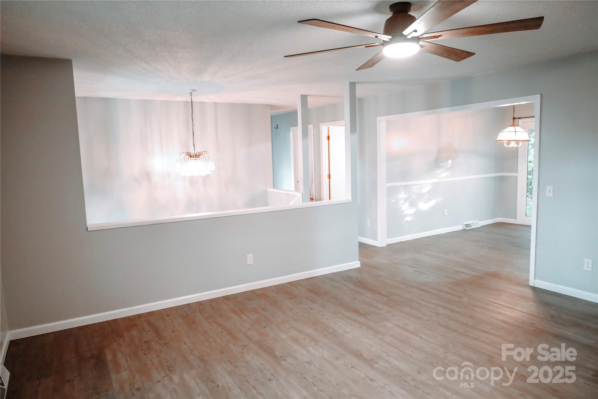 7 Windy Hollow Road Asheville, NC 28806 - Photo 12 of 39 a view of empty room with wooden floor and fan