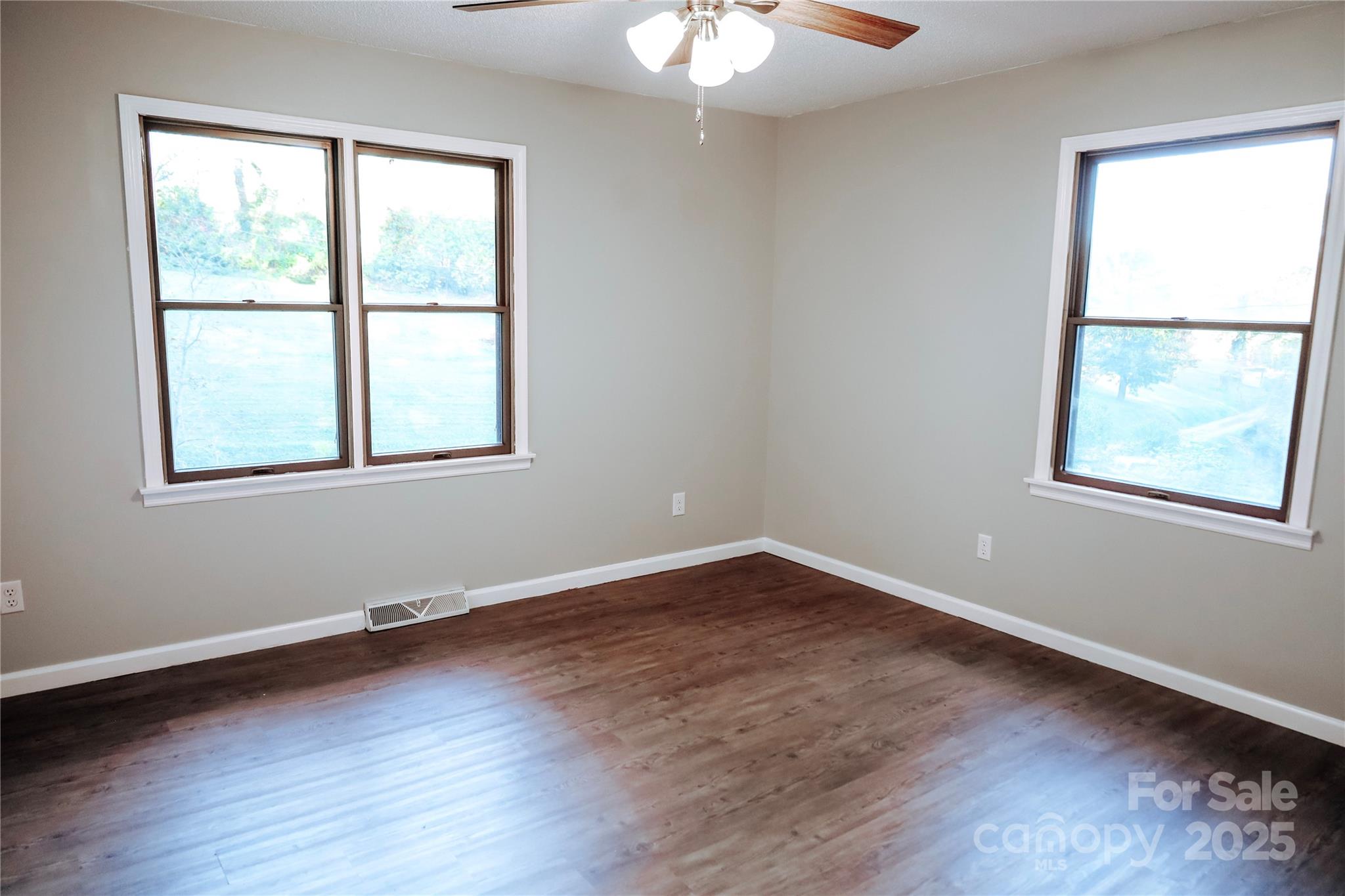 7 Windy Hollow Road Asheville, NC 28806 - Photo 16 of 39 a view of an empty room with wooden floor and a window