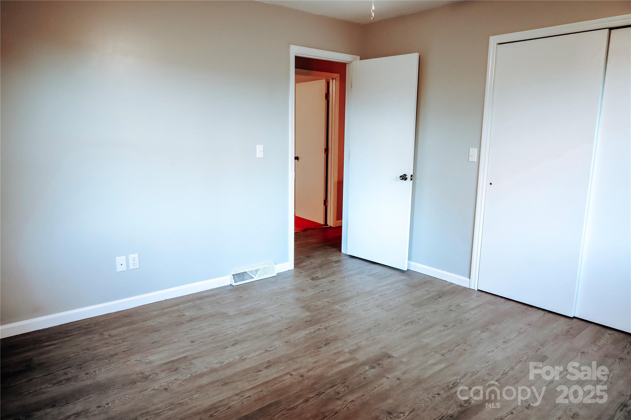 7 Windy Hollow Road Asheville, NC 28806 - Photo 17 of 39 a view of an empty room with wooden floor and closet
