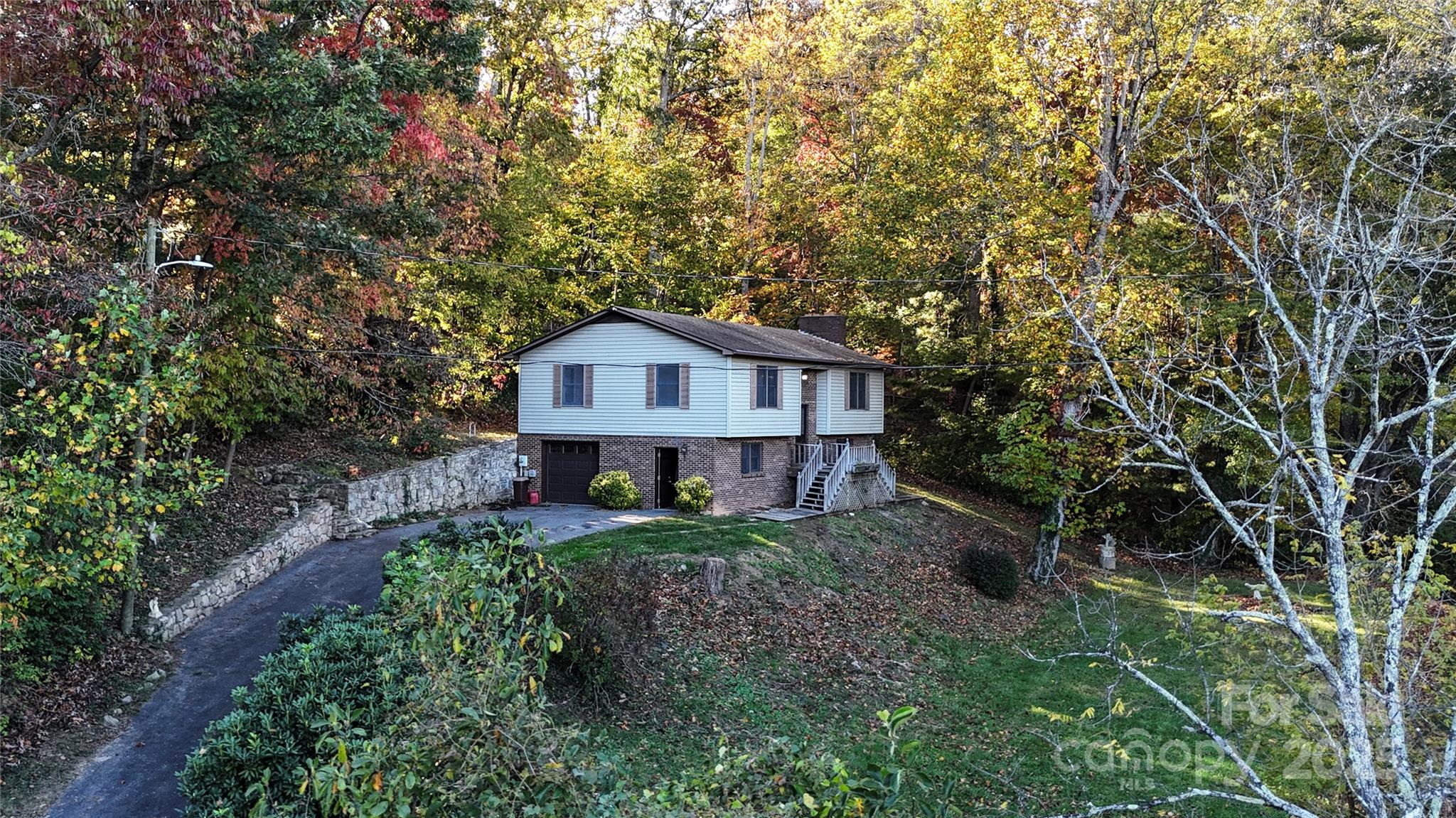 7 Windy Hollow Road Asheville, NC 28806 - Photo 2 of 39 a view of a house with a small yard plants and large tree