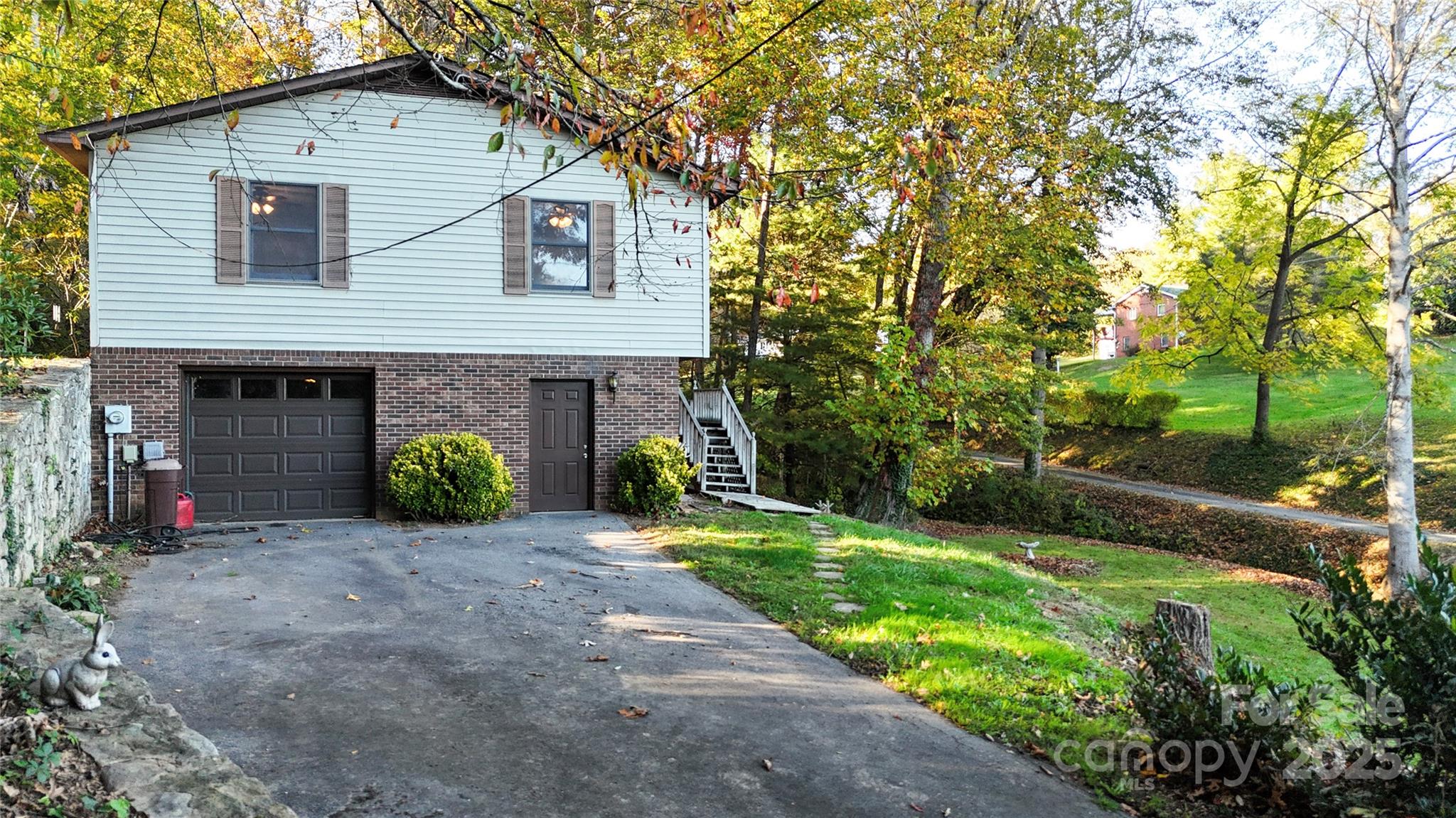 7 Windy Hollow Road Asheville, NC 28806 - Photo 27 of 39 a front view of a house with garden