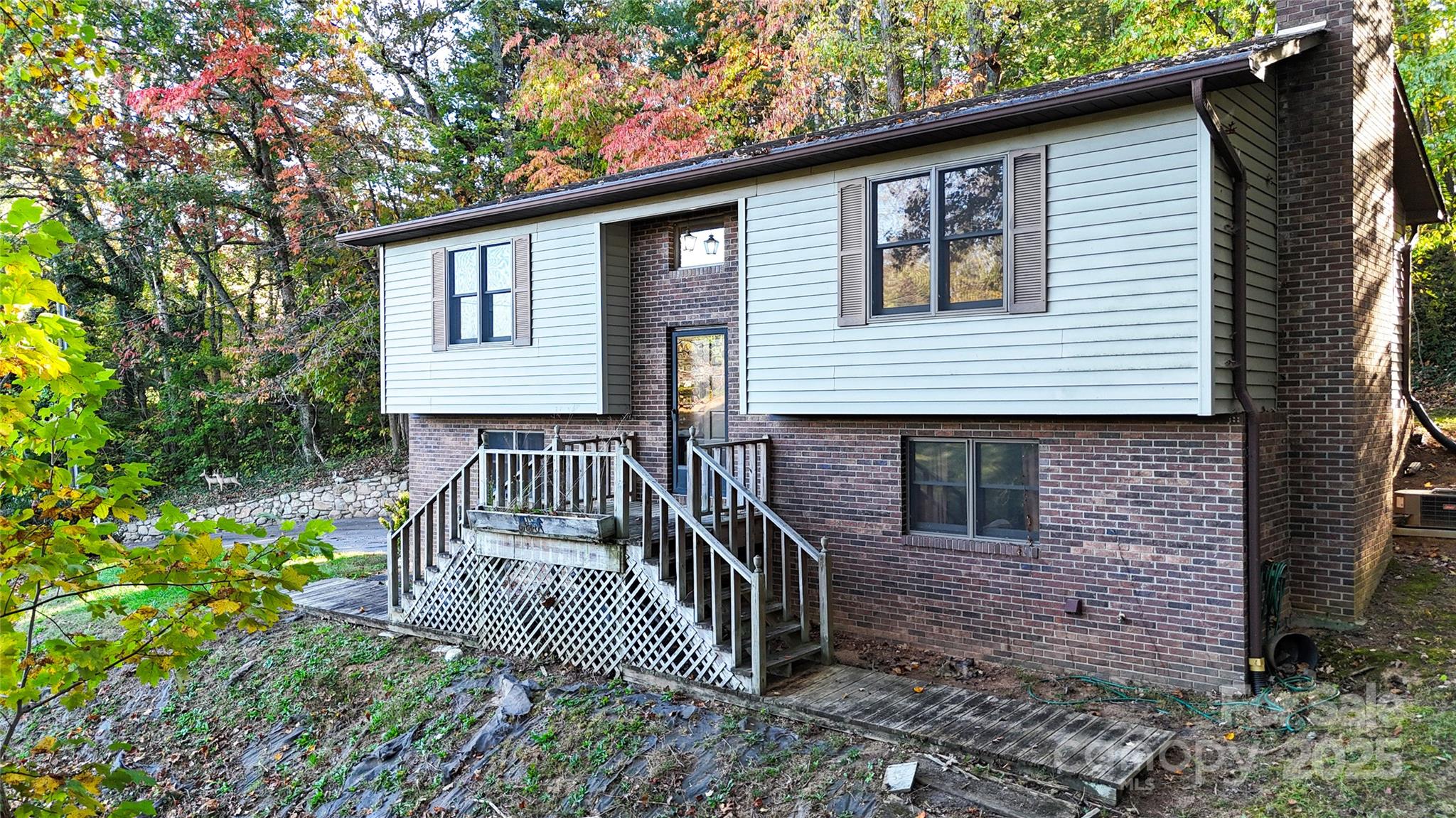 7 Windy Hollow Road Asheville, NC 28806 - Photo 29 of 39 a view of a house with brick walls and wooden fence
