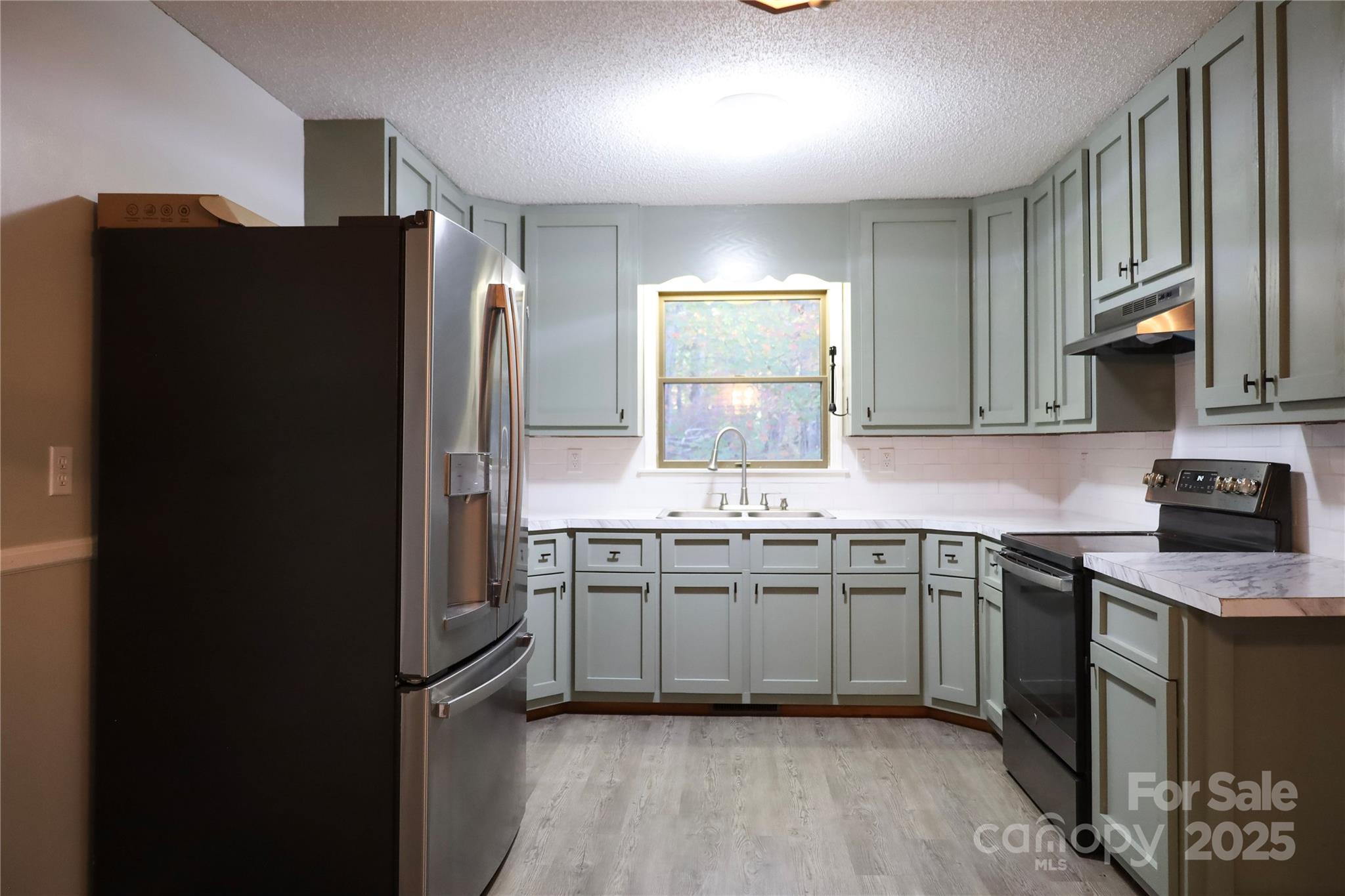 7 Windy Hollow Road Asheville, NC 28806 - Photo 6 of 39 a kitchen with stainless steel appliances granite countertop a refrigerator and a sink