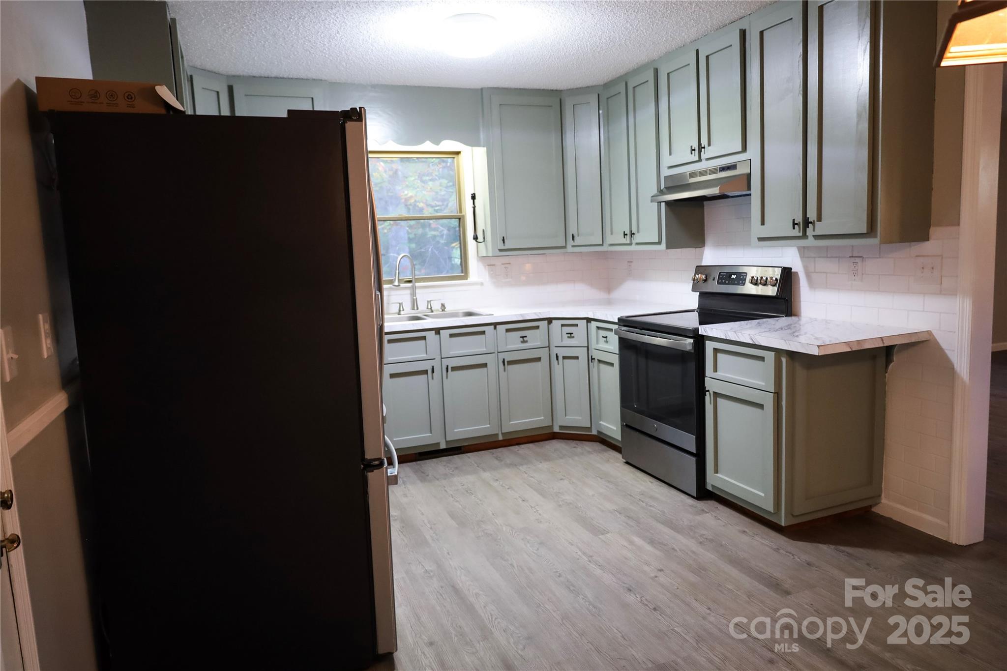 7 Windy Hollow Road Asheville, NC 28806 - Photo 7 of 39 a kitchen with stainless steel appliances granite countertop a refrigerator and a sink