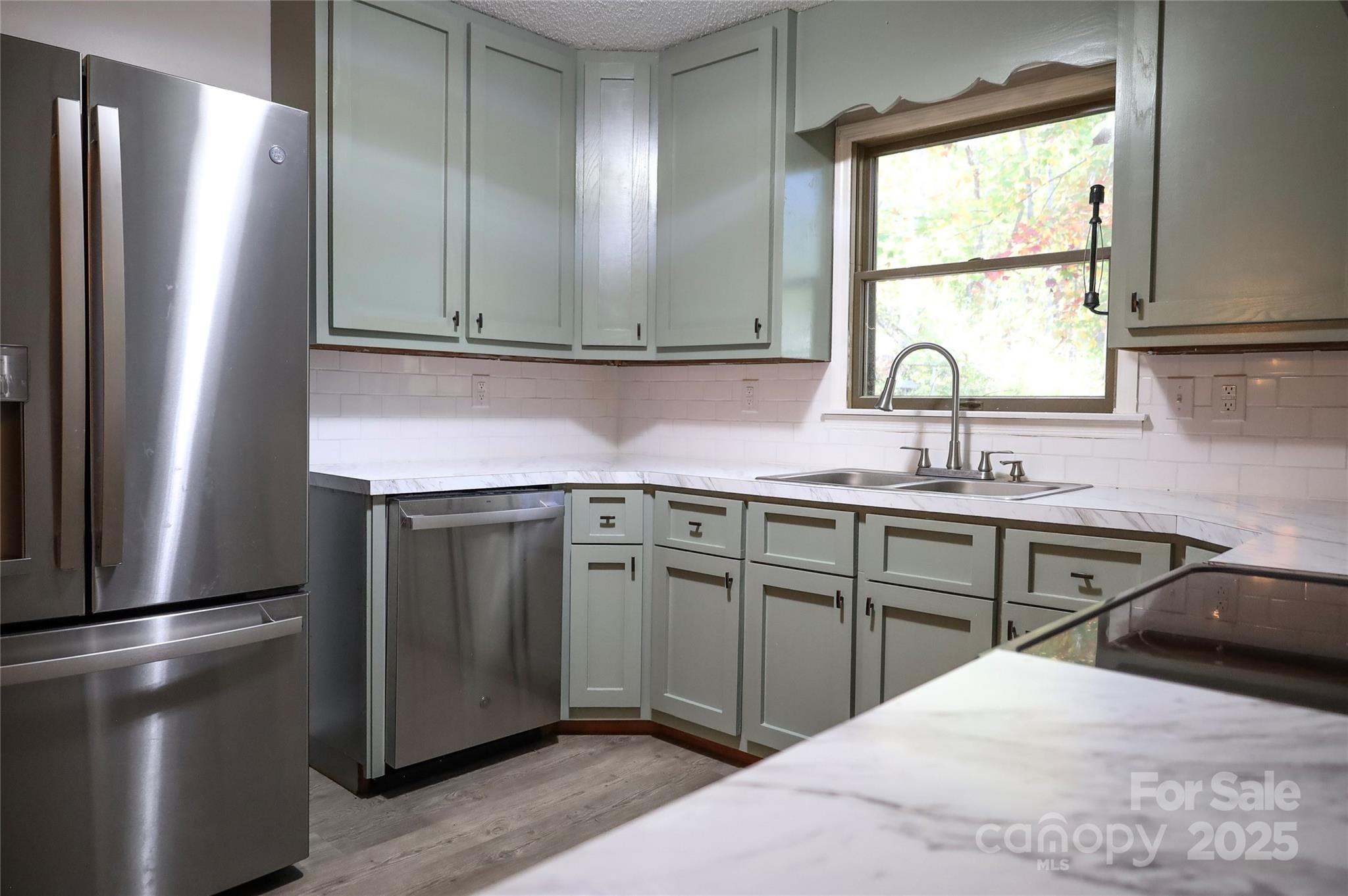 7 Windy Hollow Road Asheville, NC 28806 - Photo 8 of 39 a kitchen with stainless steel appliances granite countertop a sink stove and refrigerator