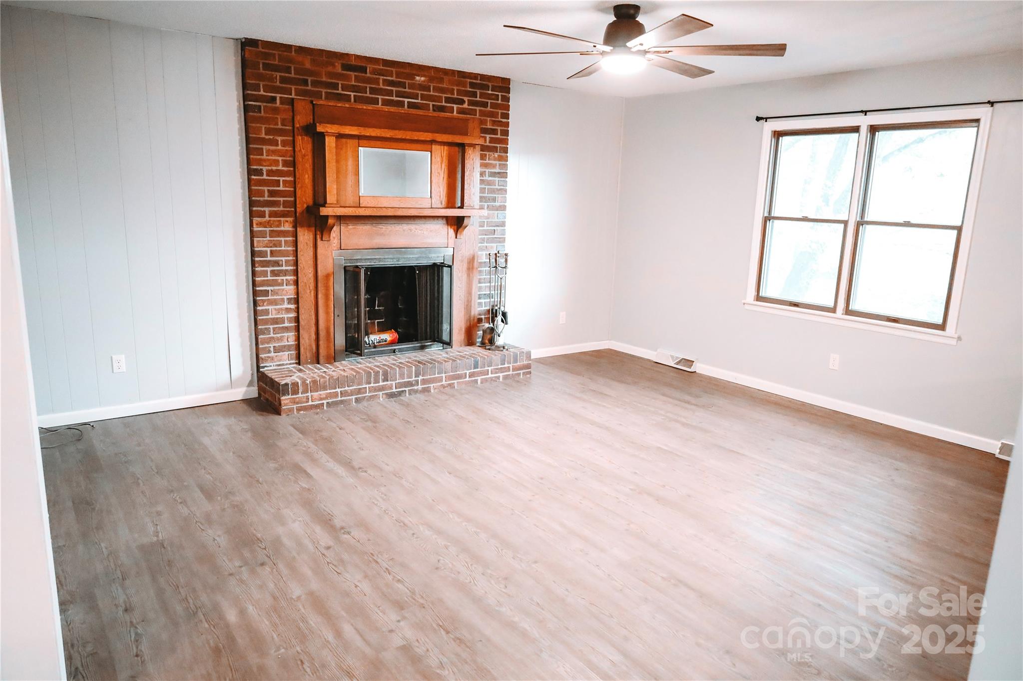 7 Windy Hollow Road Asheville, NC 28806 - Photo 10 of 39 an empty room with windows and fireplace