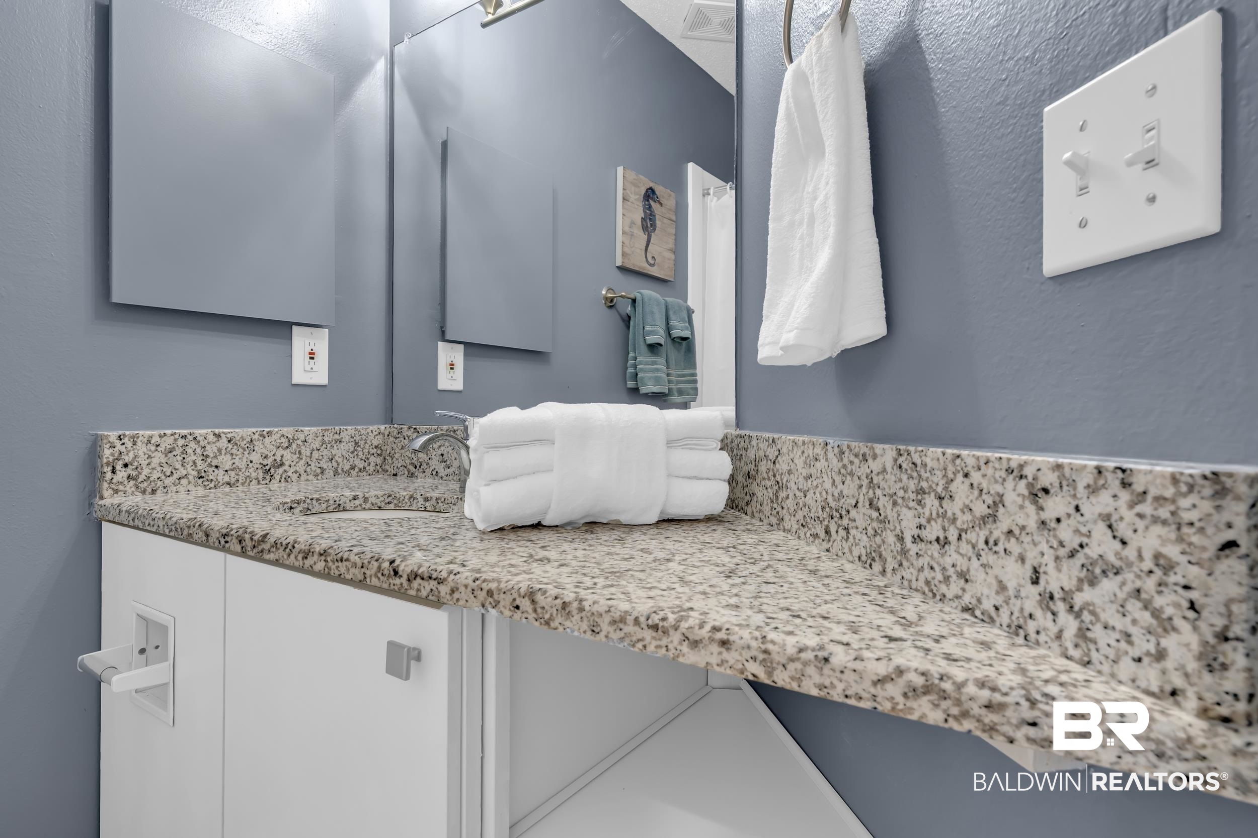 27222 Gulf Road, Unit 33 Orange Beach, AL 36561 - Photo 24 of 29 Bathroom vanity featuring a speckled countertop, integrated sink, and undermount cabinetry