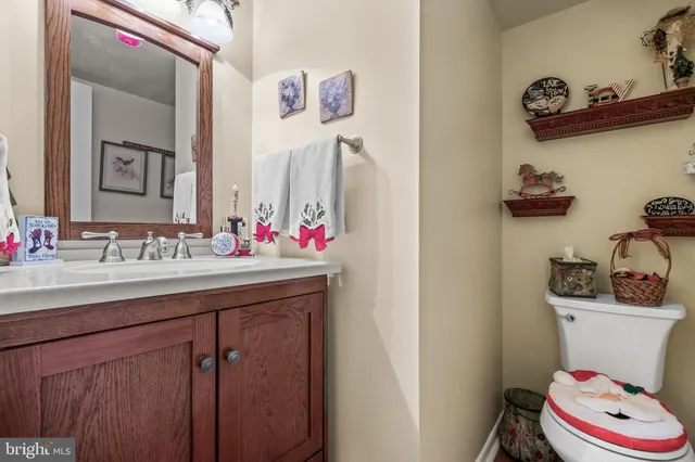 a bathroom with a sink vanity mirror and toilet