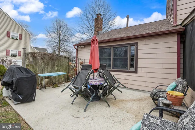 a view of a backyard with furniture and a grill