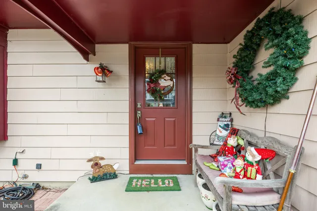 a view of front door of house and flowers