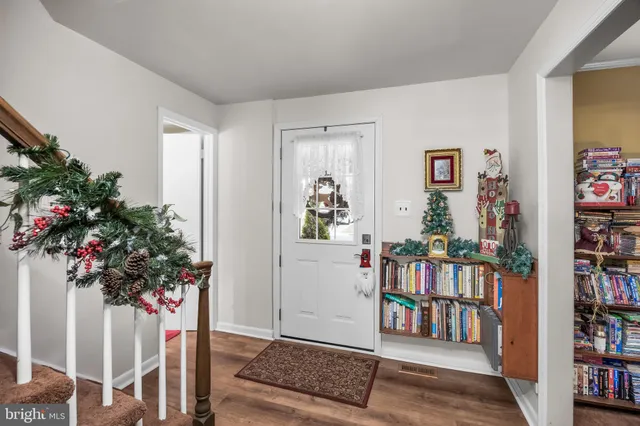 a living room with furniture and a book shelf