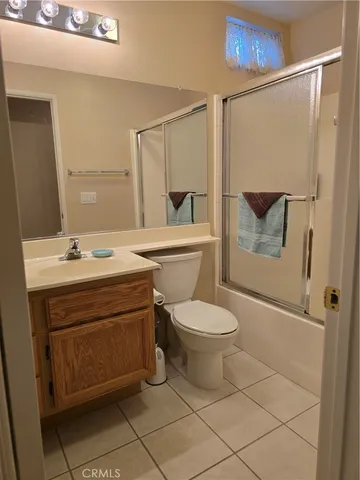 a bathroom with double vanity and a mirror