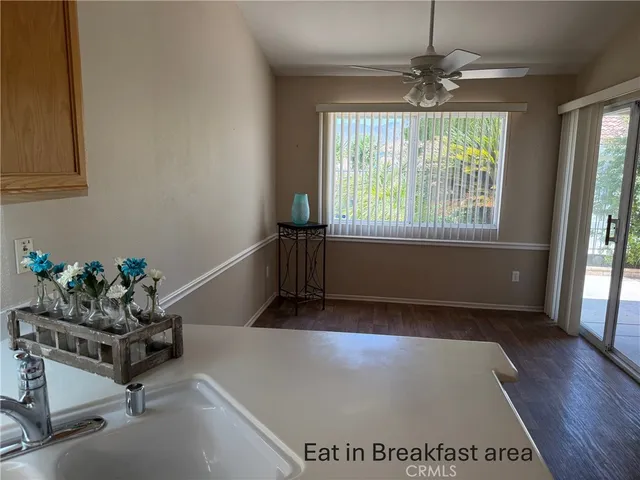 a utility room with a sink a toilet and a window