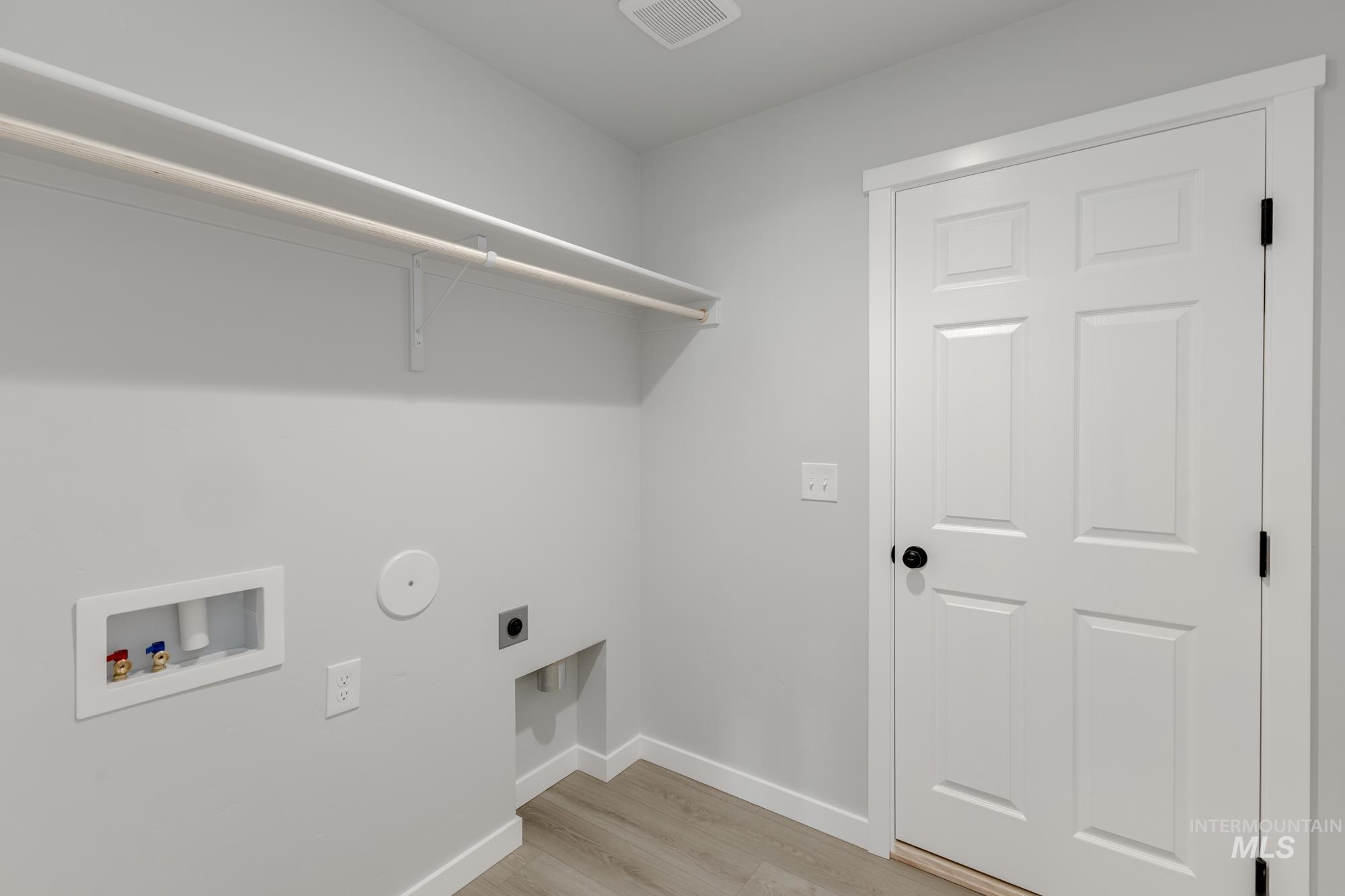 1804 West Unforgettable Street Meridian, ID 83642 - Photo 13 of 18 Laundry area with electric dryer hookup, light wood finished floors, and washer hookup