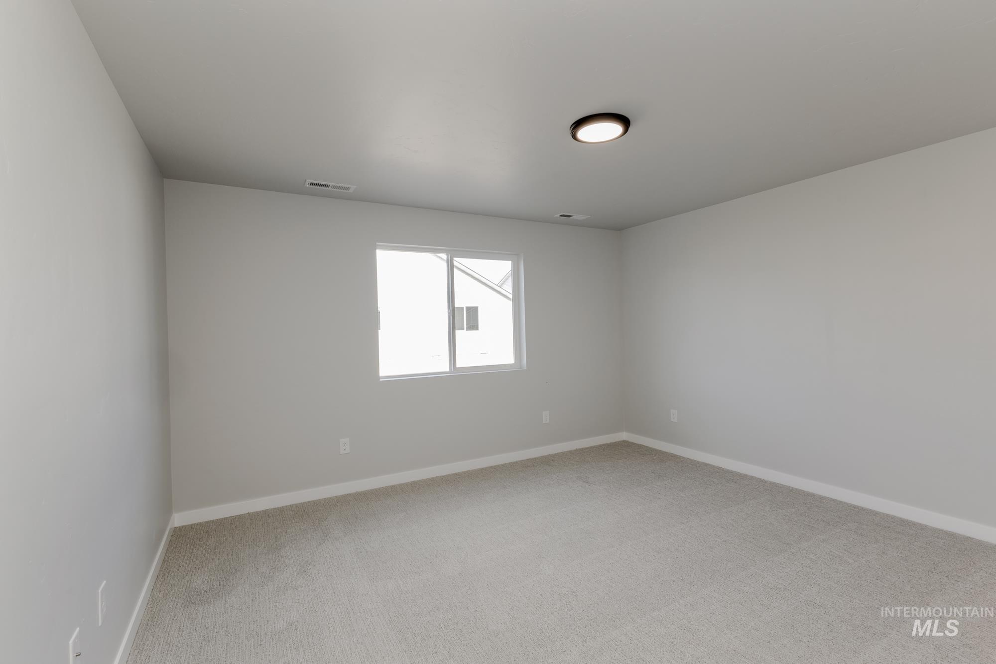 1804 West Unforgettable Street Meridian, ID 83642 - Photo 14 of 18 Spare room with light colored carpet and baseboards