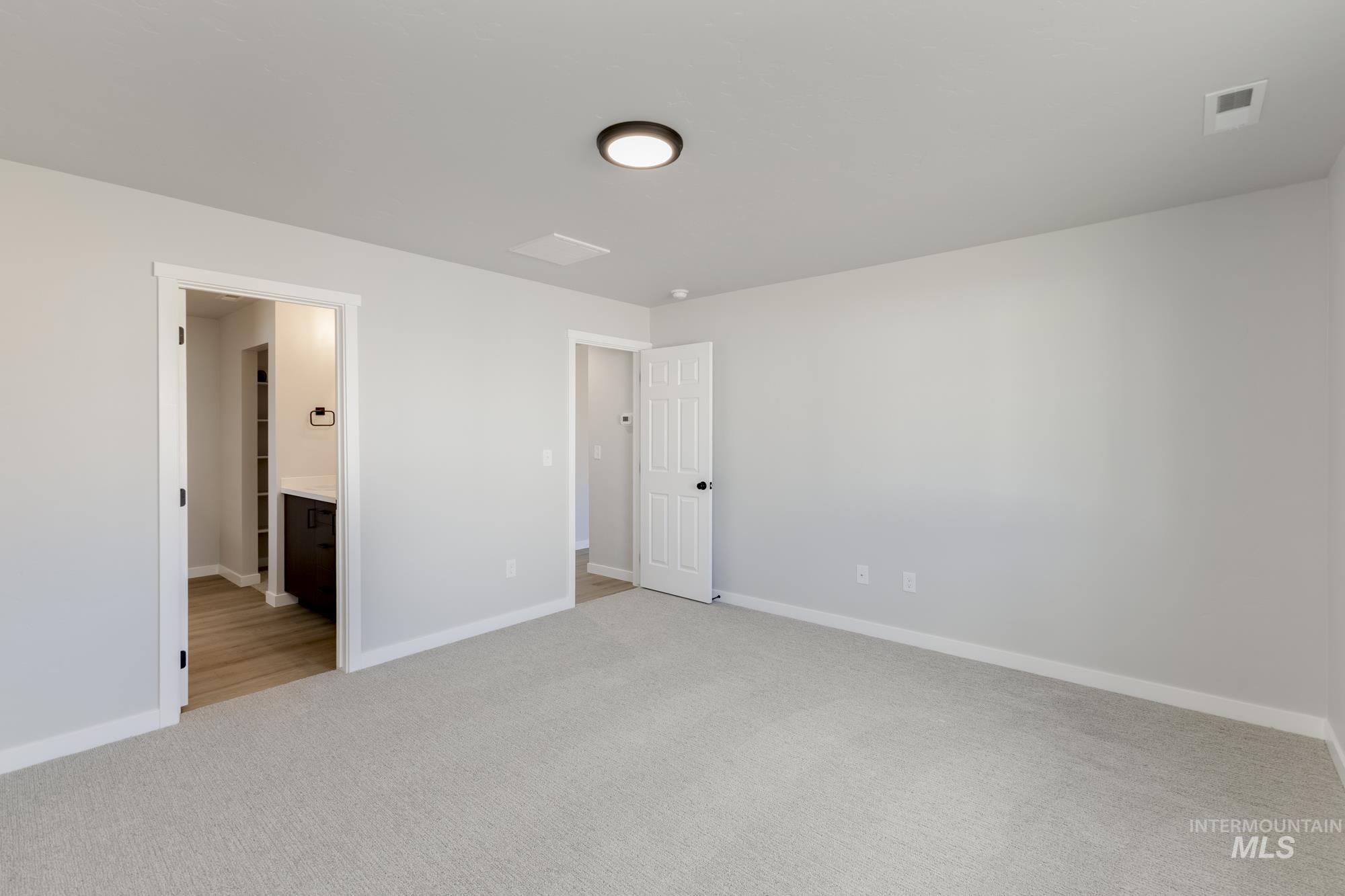 1804 West Unforgettable Street Meridian, ID 83642 - Photo 15 of 18 Unfurnished bedroom with light carpet and ensuite bathroom