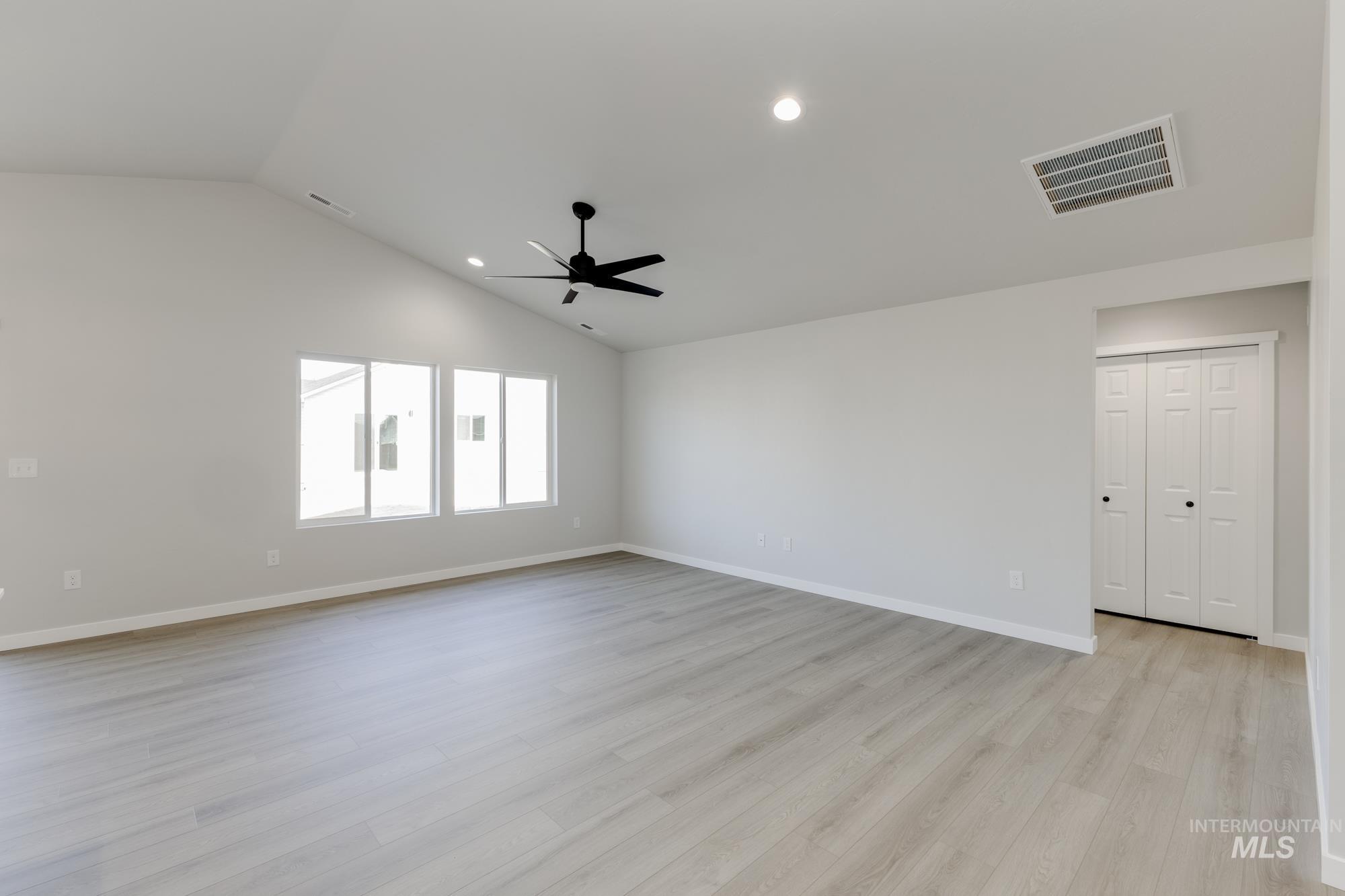 1804 West Unforgettable Street Meridian, ID 83642 - Photo 7 of 18 Spare room featuring recessed lighting, light wood-style flooring, vaulted ceiling, and ceiling fan