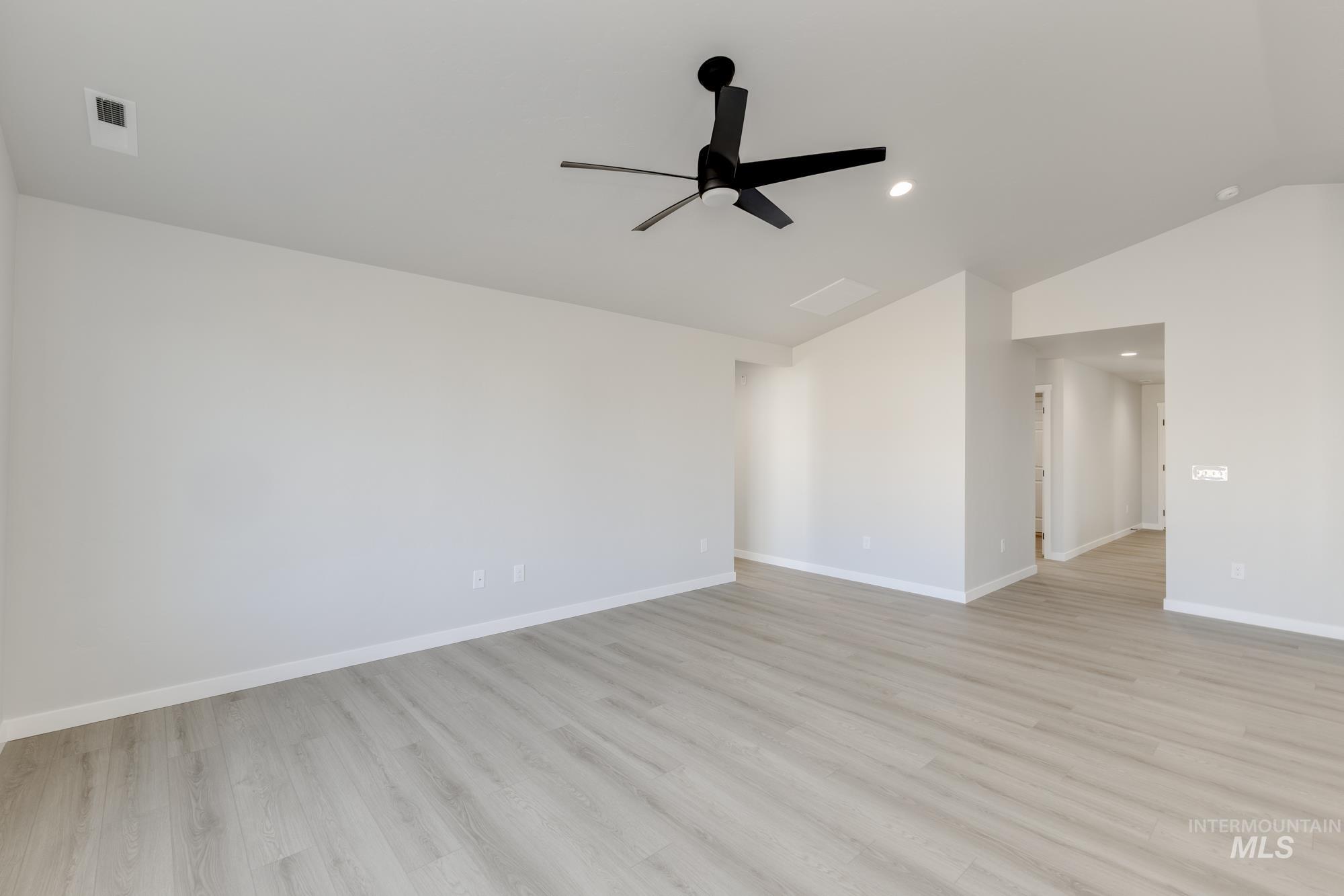 1804 West Unforgettable Street Meridian, ID 83642 - Photo 8 of 18 Empty room with lofted ceiling, light wood-type flooring, a ceiling fan, and recessed lighting