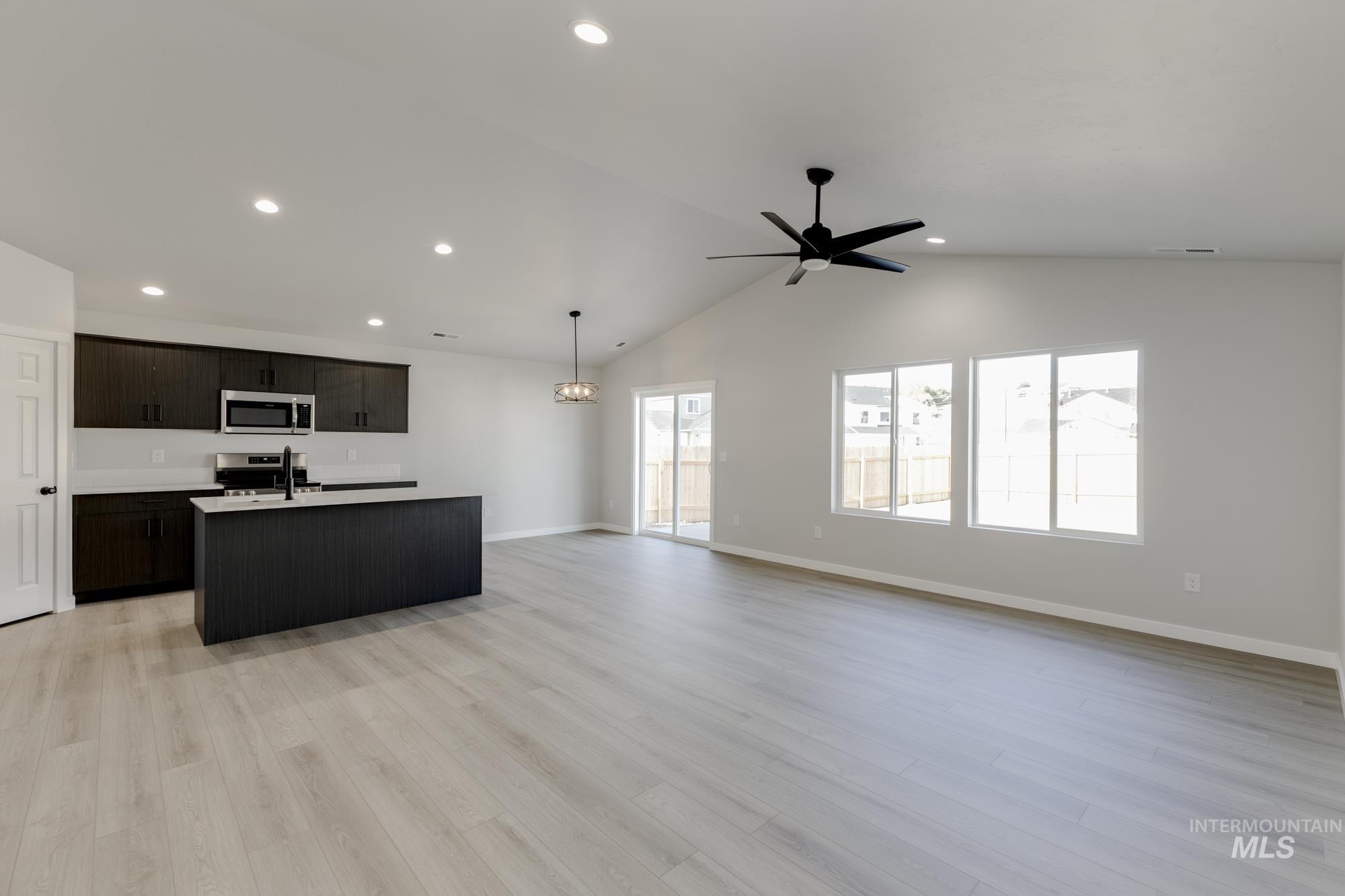 1804 West Unforgettable Street Meridian, ID 83642 - Photo 18 of 18 Kitchen featuring a kitchen island with sink, open floor plan, recessed lighting, light wood-type flooring, and stainless steel appliances