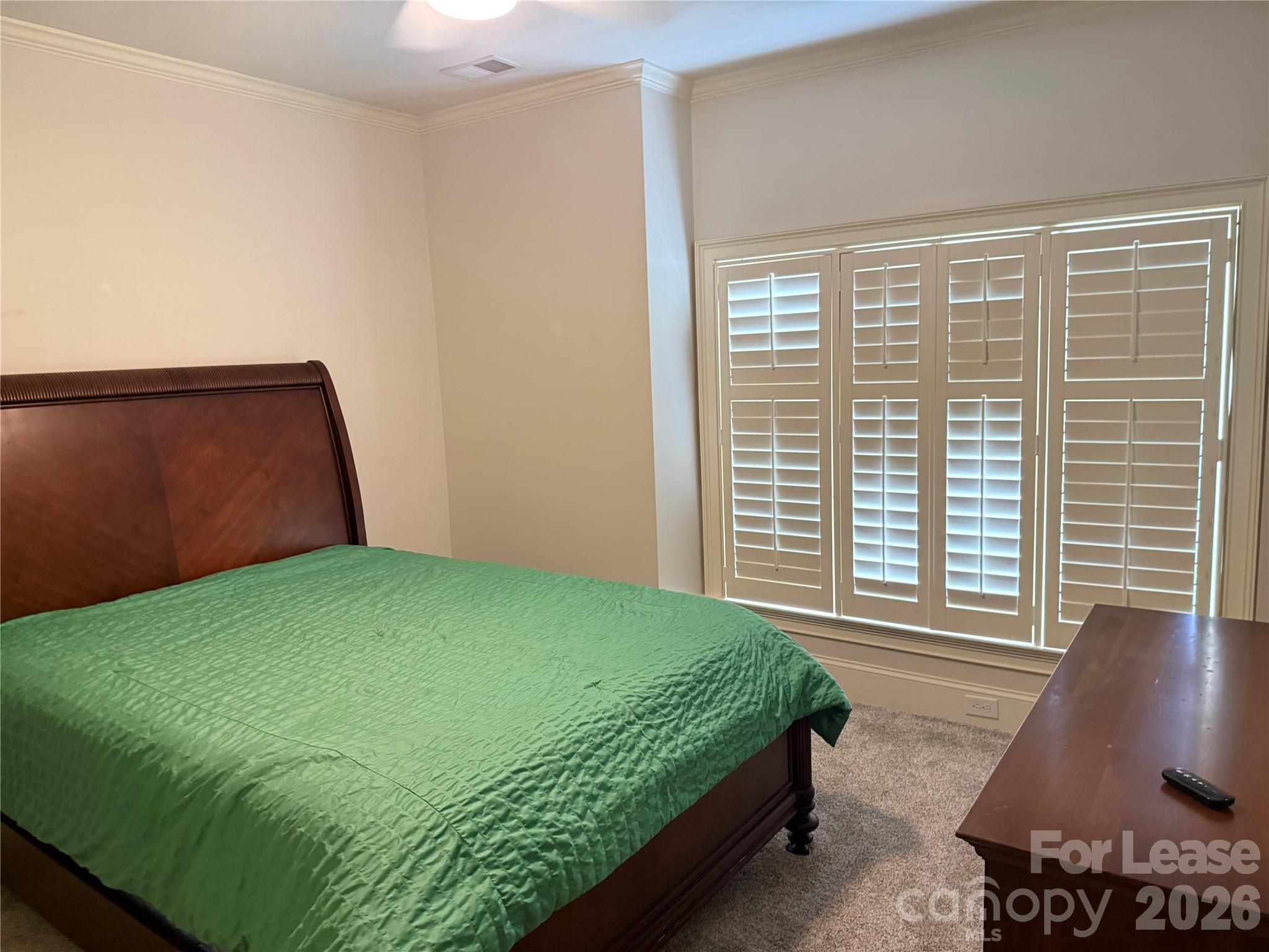 421 Spring Street Davidson, NC 28036 - Photo 14 of 24 a bedroom with a bed and chair