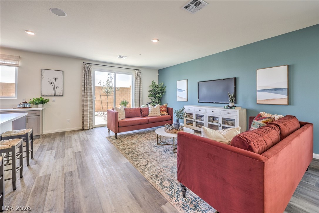 1017 Copper Robin Street Henderson, NV 89011 - Photo 10 of 43 Living area with light wood-style flooring, baseboards, and recessed lighting. Photo is representational only; actual home finishes may vary