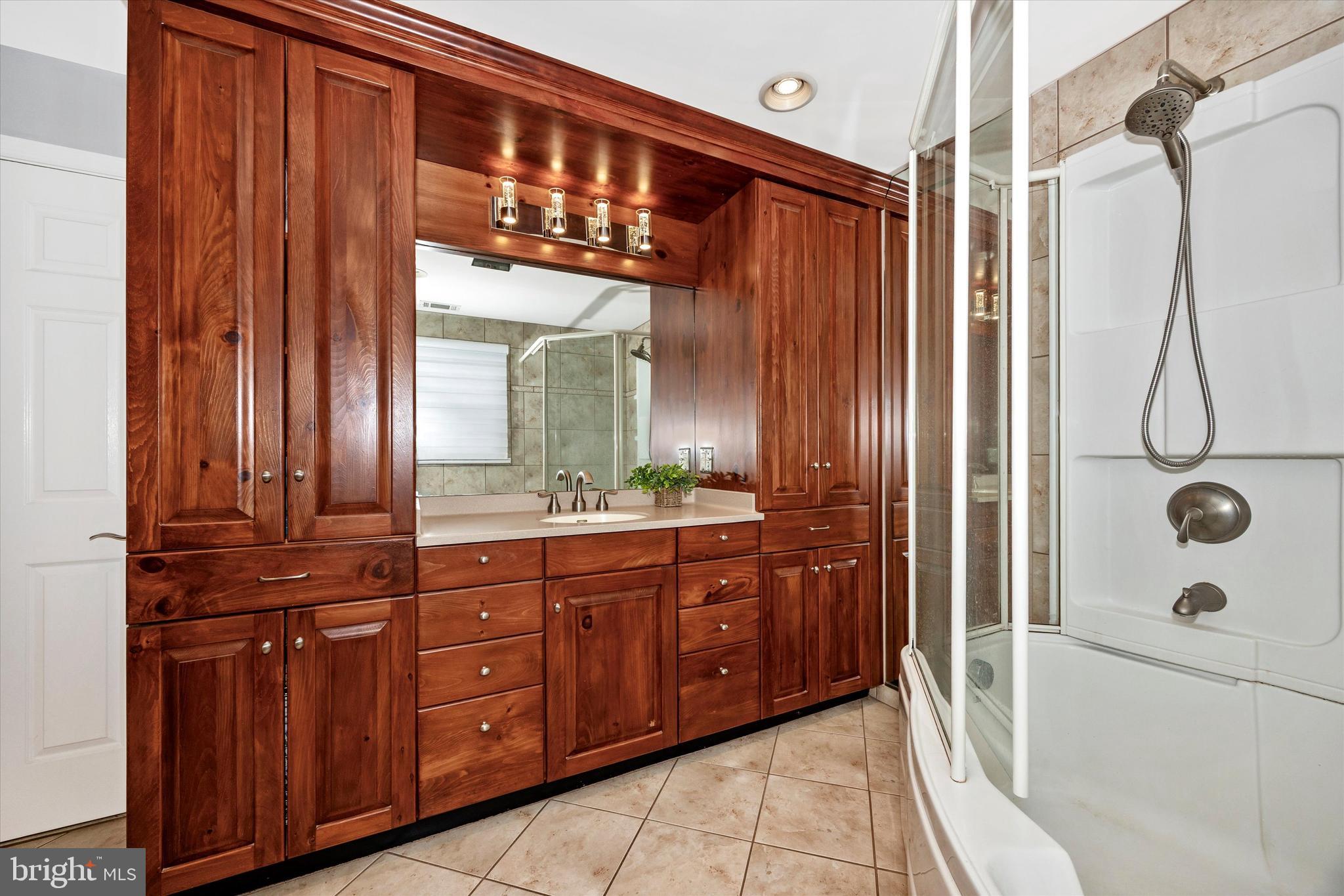 307 Redwood Avenue Frederick, MD 21701 - Photo 13 of 23 a bathroom with a granite countertop sink and a mirror