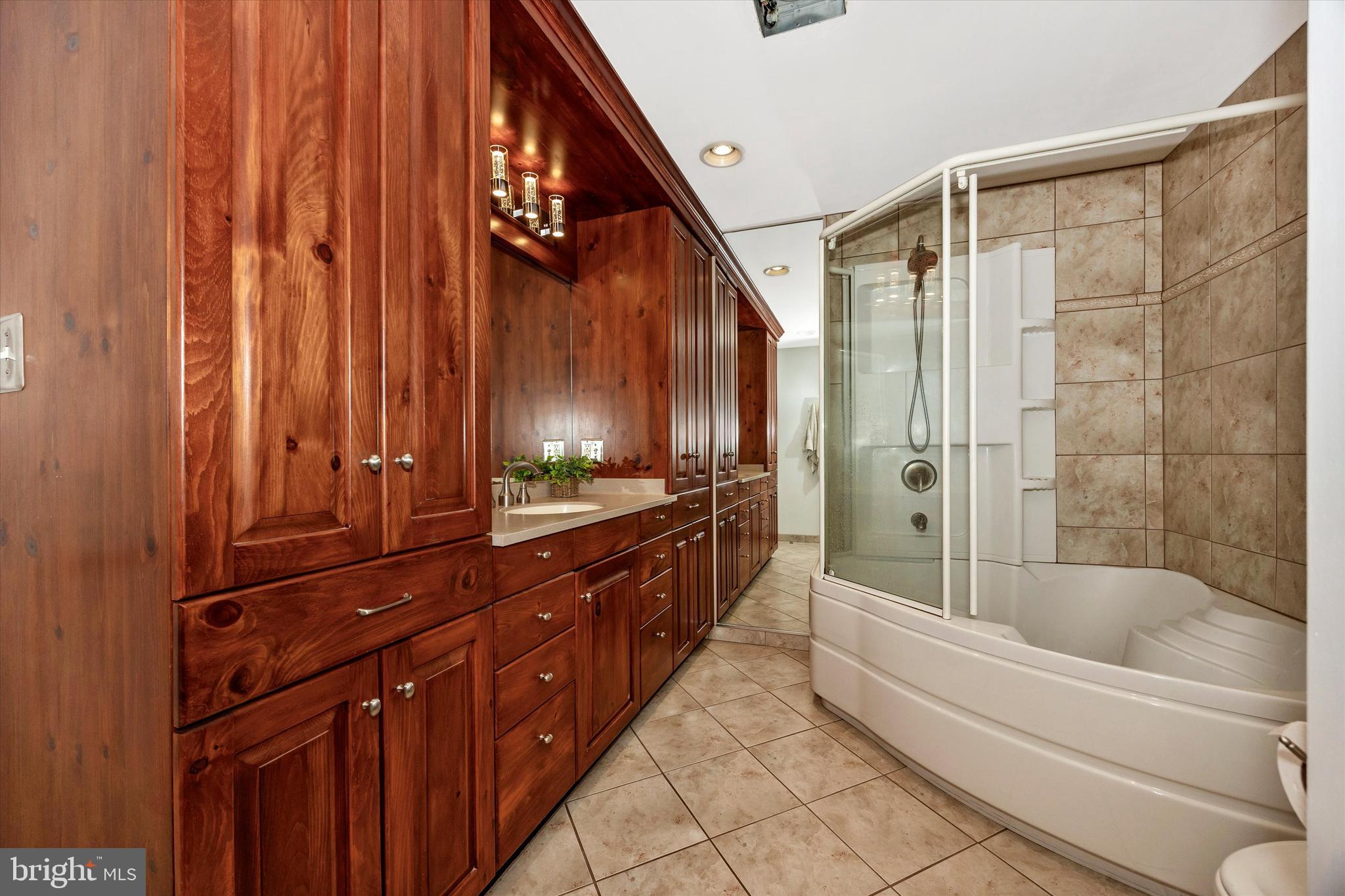 307 Redwood Avenue Frederick, MD 21701 - Photo 14 of 23 a bathroom with a sink a mirror and a bathtub