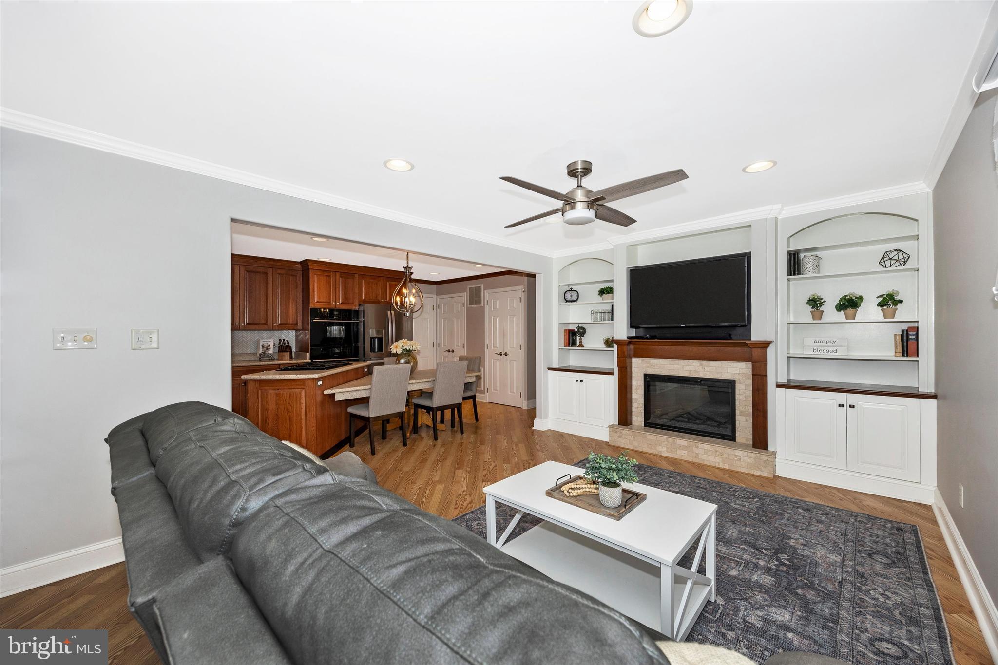 307 Redwood Avenue Frederick, MD 21701 - Photo 3 of 23 a living room with furniture a fireplace and a flat screen tv